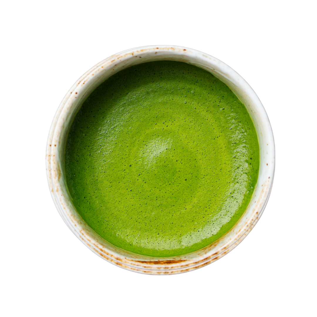 Green matcha in a white bowl on a white background
